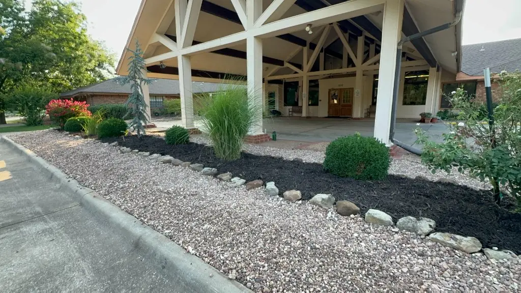 Rock groundcover and planted landscape beds beside the entrance at Christian Villa